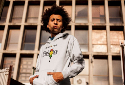 Man with Afro wearing a Zimbabwean T-Shirt that says Robots
