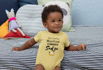 Happy black baby wearing yellow Sadza onesie bodysuit by ZimXcite for Zimbabwean fashion