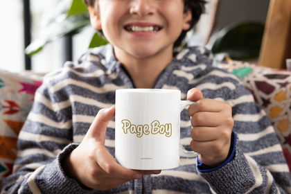 Young white boy holding a white mug that says Page Boy